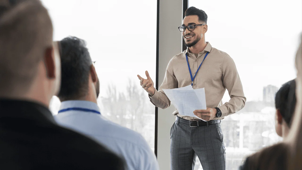 A presenter confidently speaking to an engaged audience